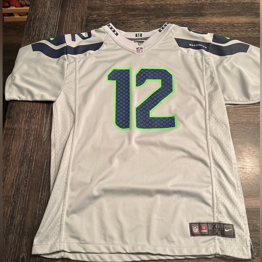 Seahawks 12 man jersey children’s size XL. Fits like men’s XS.